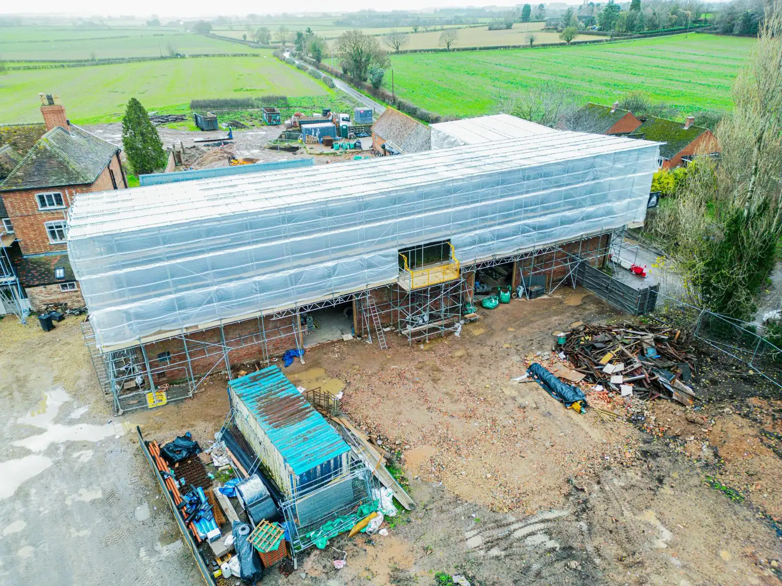 Aerial view of a long temporary roof protecting a building project